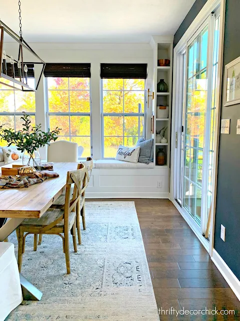 Long window seat dining room with bookcases and lights