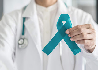 Doctor holding teal ribbon