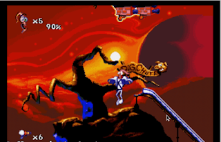 Shows Earthworm Jim running in bright red background with dark brown tree like dead style here next to a silver slide saying Pigchute and Earthjim has x5 to represent his lives and also 6 next to represent his current gum ammo plus  like brick version of cameras two of them above his head
