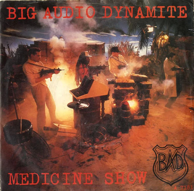 Big Audio Dynamite - Medicine Show (1986) - Note cameo appearances by Joe Strummer and Paul Simonon as the two cops and John Lydon firing an Uzi