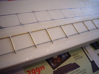 Installation of white tulle to brass frame using super glue