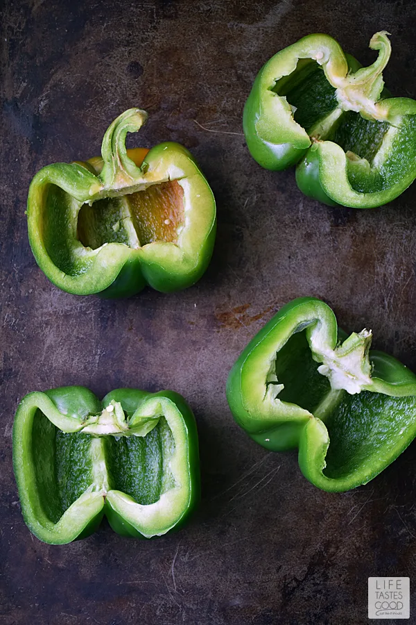 Green Peppers | by Life Tastes Good are stuffed with a mixture of turkey sausage, spinach, fresh herbs & Basmati rice in a spicy salsa topped off with ooey gooey cheese are easy to make and packed full of exciting flavors. #LTGrecipes