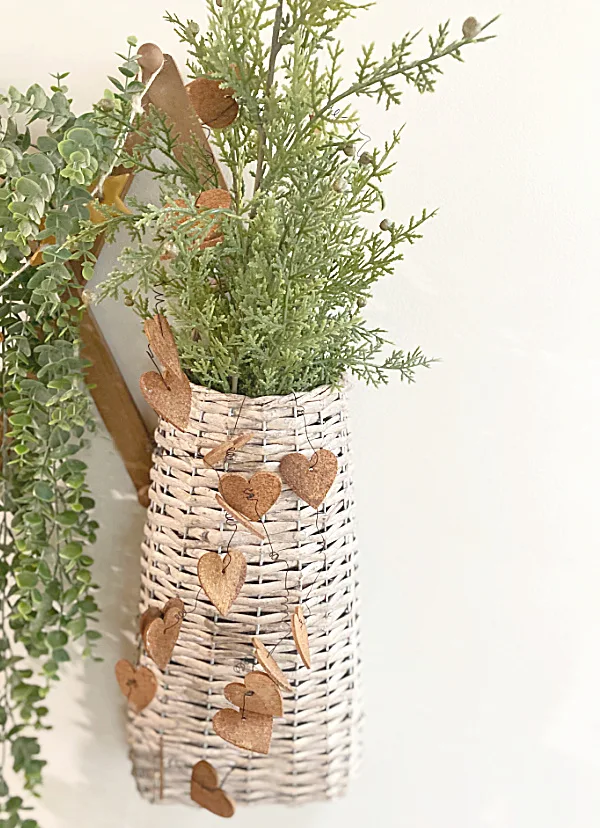 Rusty heart garland on a basket with a plant