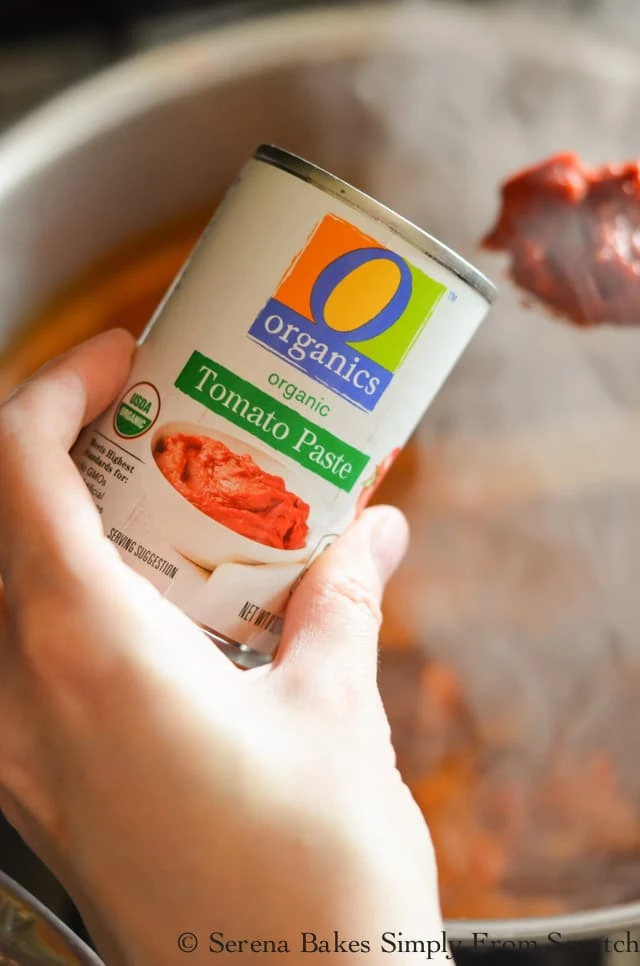 Tomato Paste being added to Mexican Meatball Soup.