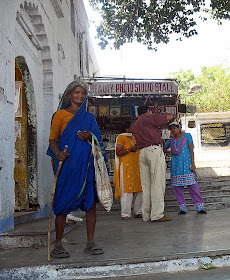 old beggar outside tourist site