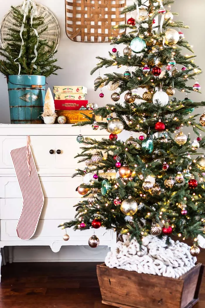 Christmas tree, antique dough box, dresser, shiny ball ornaments