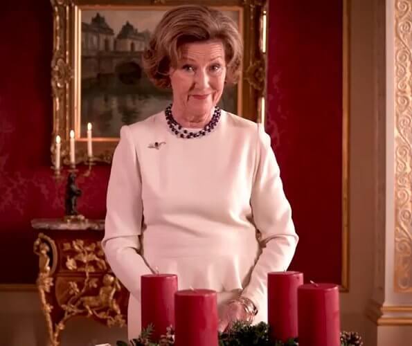 Queen Sonja of Norway wore a white suit and gold brooch, and pearl diamond necklace