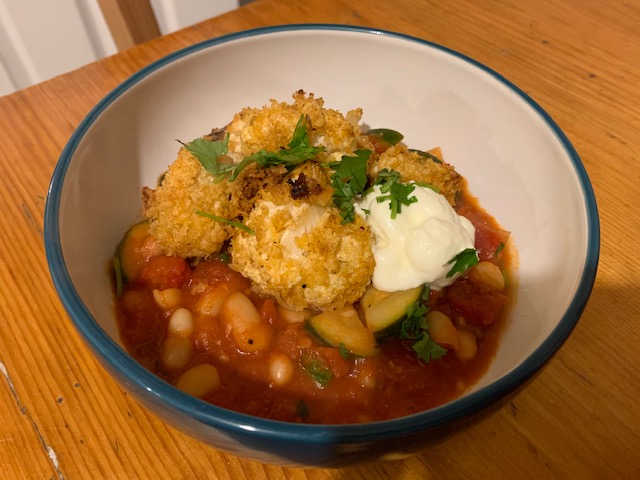 Cauliflower nuggets, with a spicy bean stew and soured cream