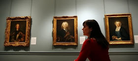 A woman looks at paintings, Jean-Marc Nattier Portrait of a Commander of the Order of the Knights of Malta, from The Collection of Louis La Caze at The Wallace Collection, in London