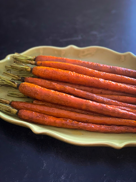 Fun and Easy Roasted Whole Caramelized Carrots, a classic, super simple side dish to grace holiday meals and family dinner tables.  The dish calls for a few straightforward ingredients that enhance the purest flavor of the carrots.