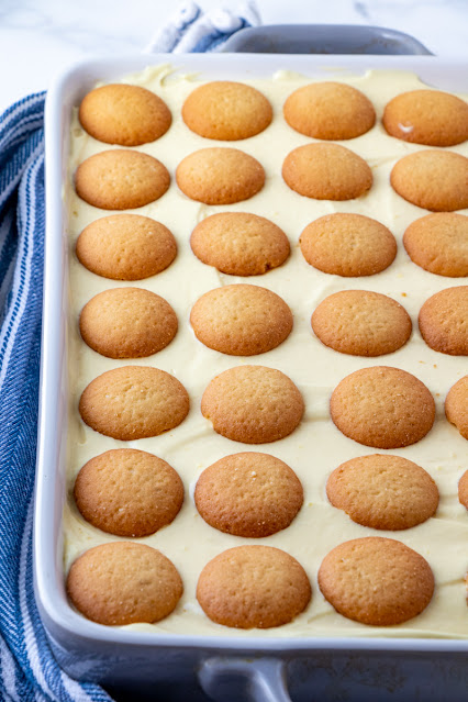 banana pudding in a pan with nilla wafers on top