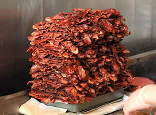 Huge pile of neatly-stacked bacon