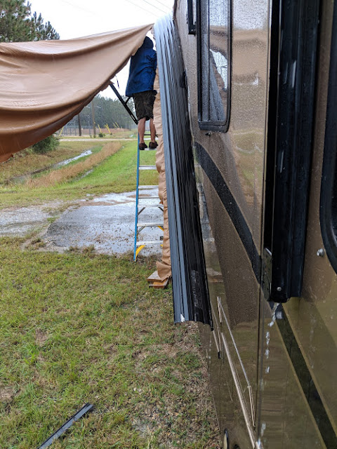 Removing our wrecked patio awning