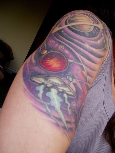 Old school UFO tattoo in outer space