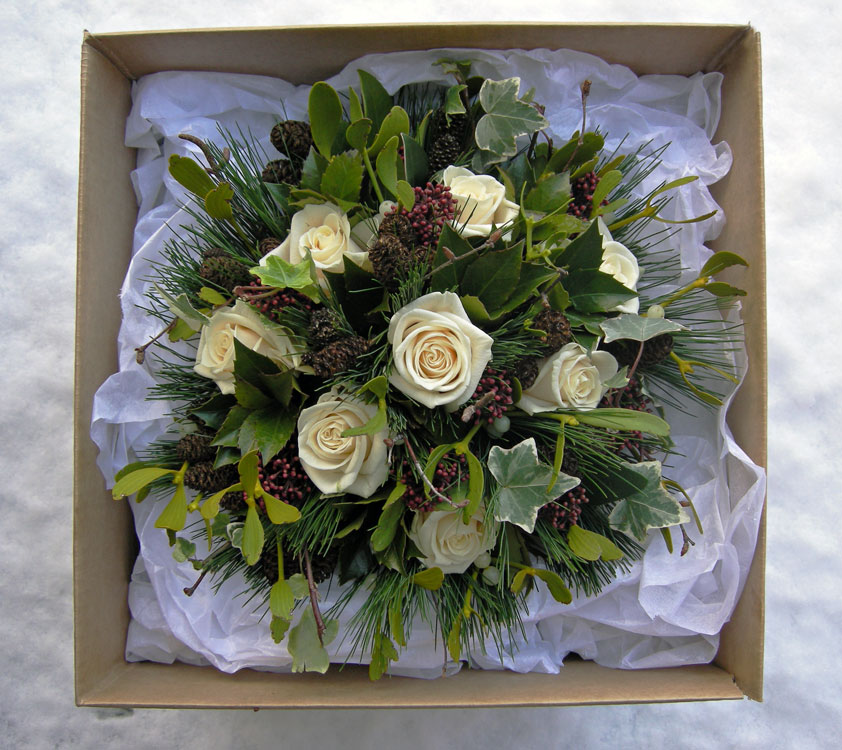 Winter wedding bouquet with a strong Christmas look of roses holly ivy 