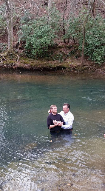An image of a Pastor in the water with a candidate to be baptized at Redwine's Cove in Dalton, GA.