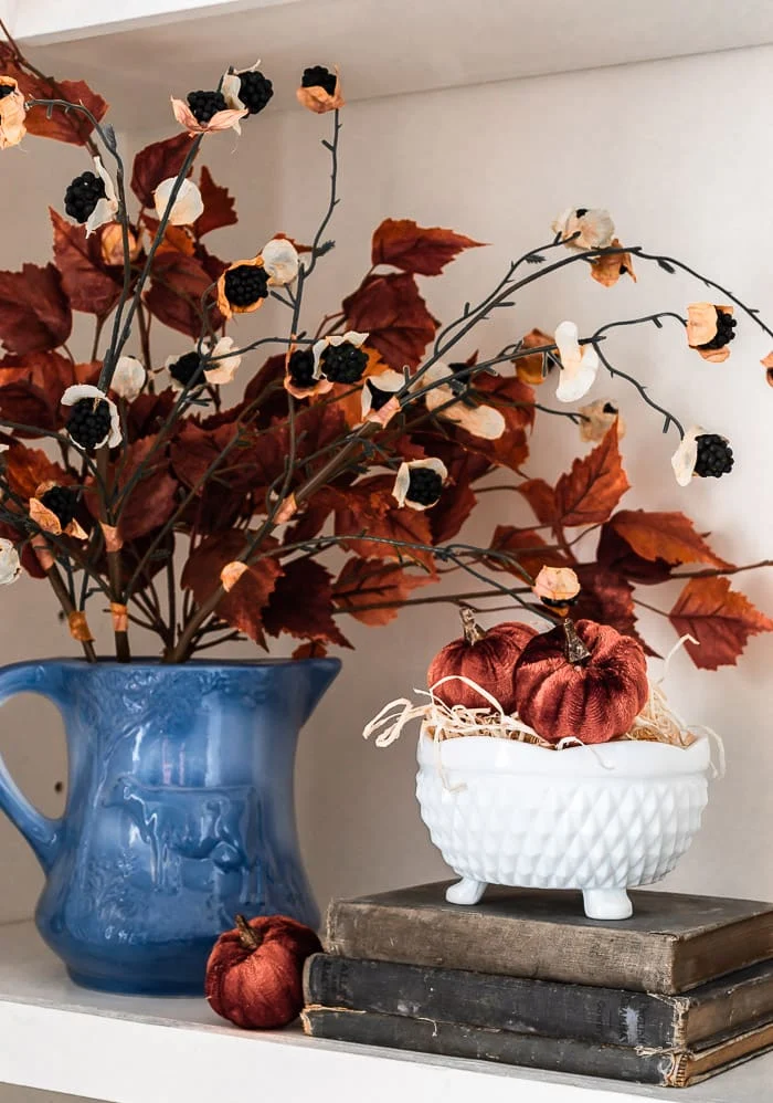 blue pitcher, rust leaves, faux blackberry stems, antique books, pumpkins