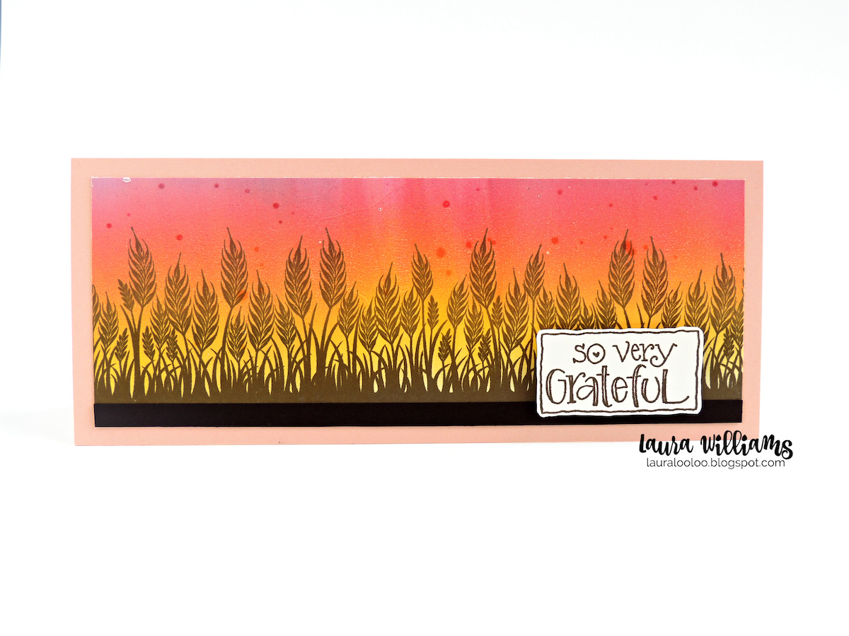 This is a slimline size handmade card (8.5x3.5") It features a wheat field stamped onto a blending pink, orange, and yellow sky that looks like sunrise or sunset. The sentiment says So Very Grateful. This would be a perfect handmade card for autumn thank you cards, or Thanskgiving cards. All of the stamps are from Impression Obsession.