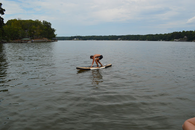 Josh trying to stand up on the paddleboard again.