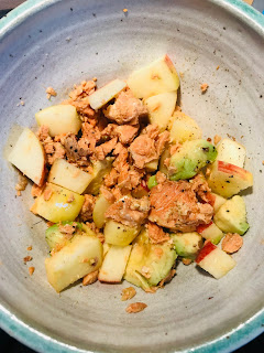 Salmon, avocado, diced apple, lime juice, olive oil and pepper in a bowl