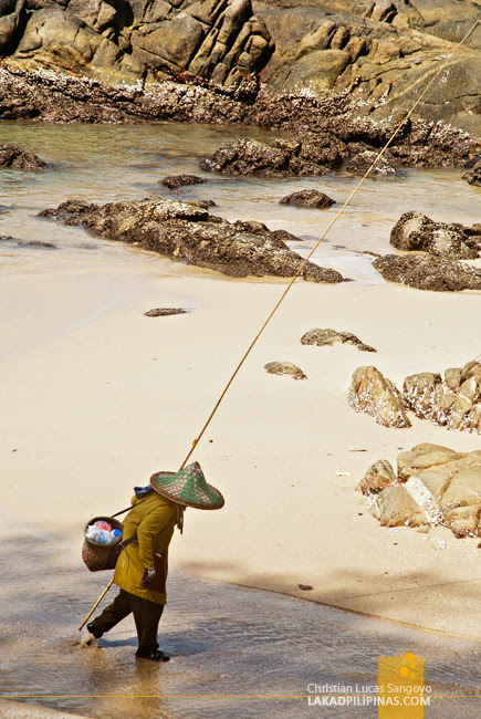 An Elderly Fisherwoman at Phuket's Patong Beach