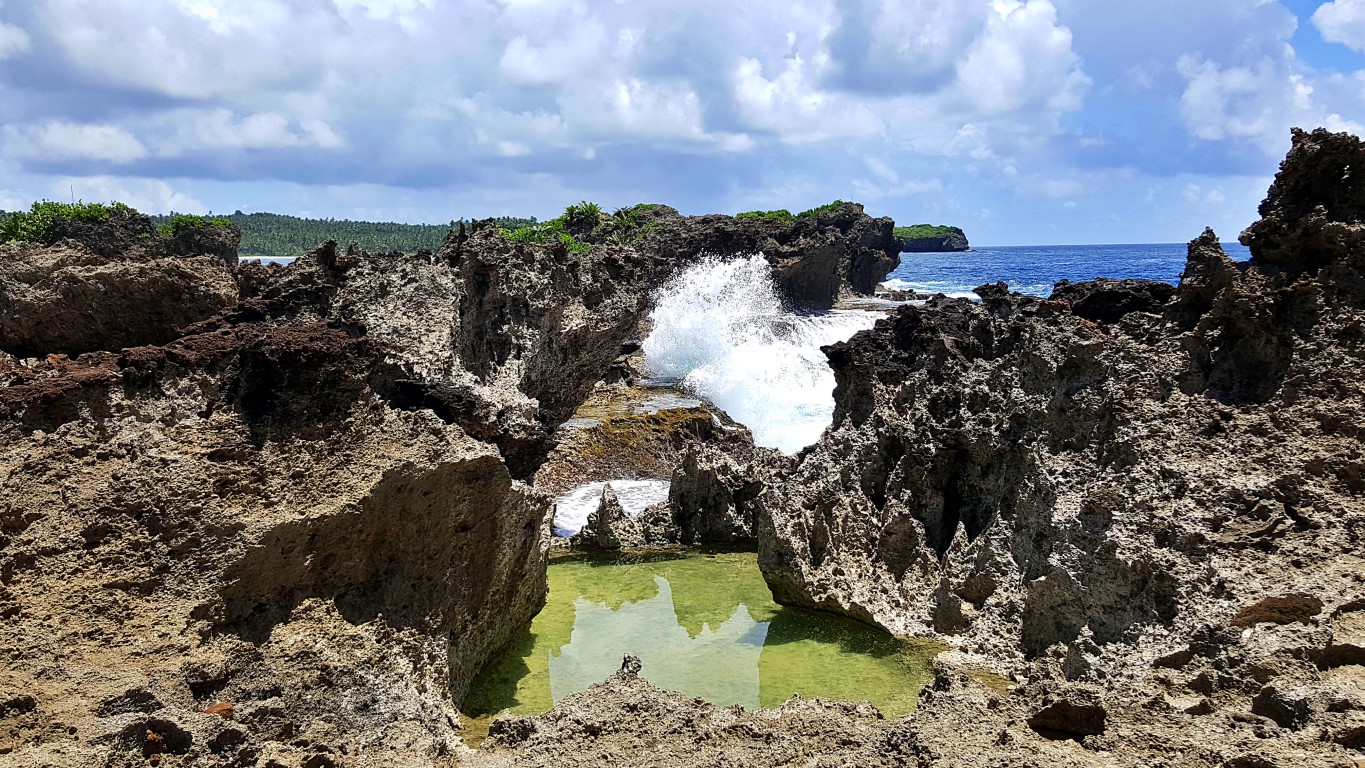 craggy cliffs being battered by giant pacific waves at Canhugas Nature Park in Hernani Eastern Samar