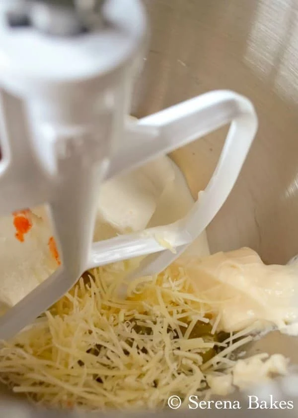 Mixing bowl with cream cheese, sour cream, mayonnaise, parmesan cheese, hot sauce,  and salt for Hot Spinach Dip.