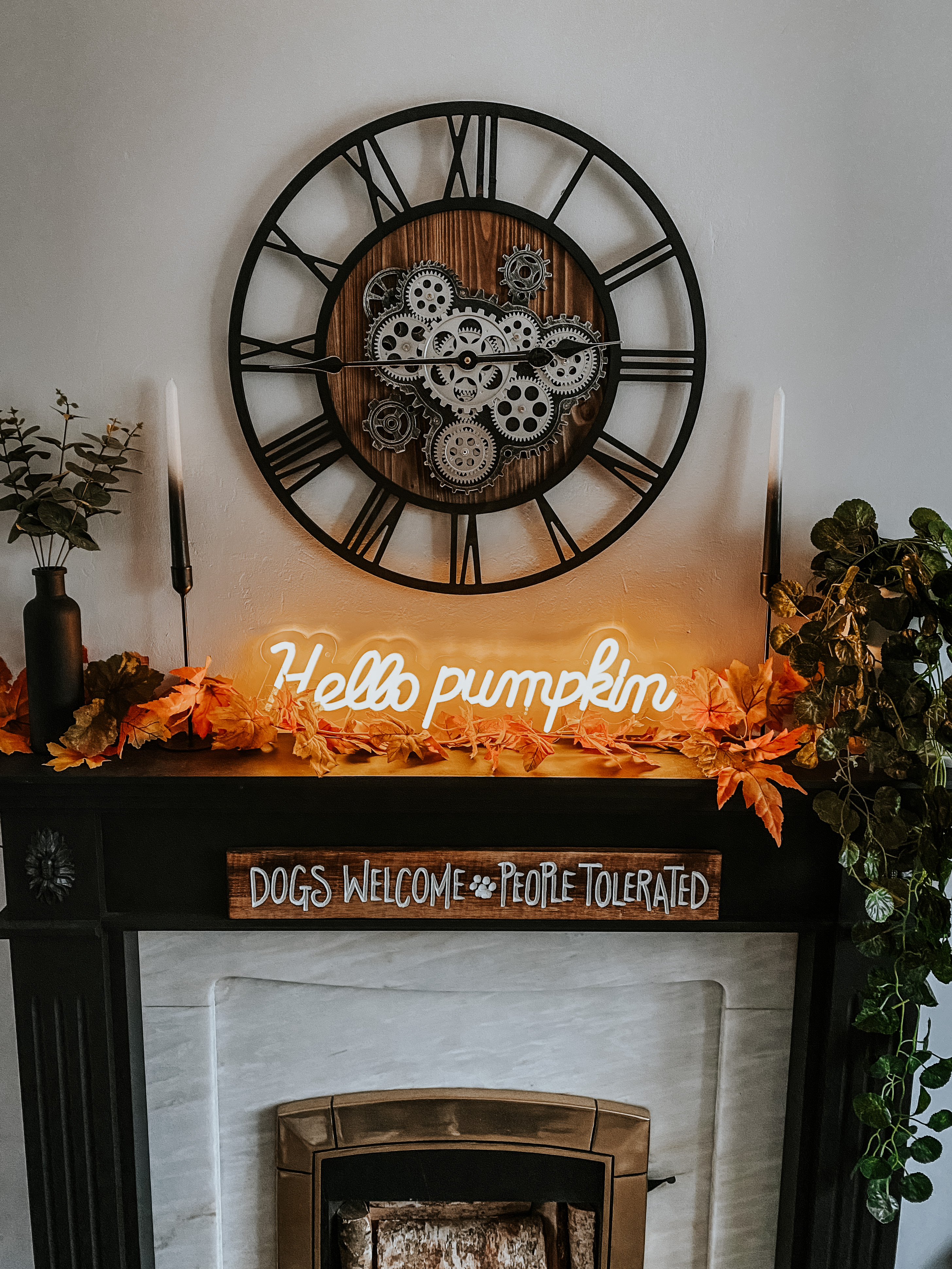 hello pumpkin neon sign on a fireplace