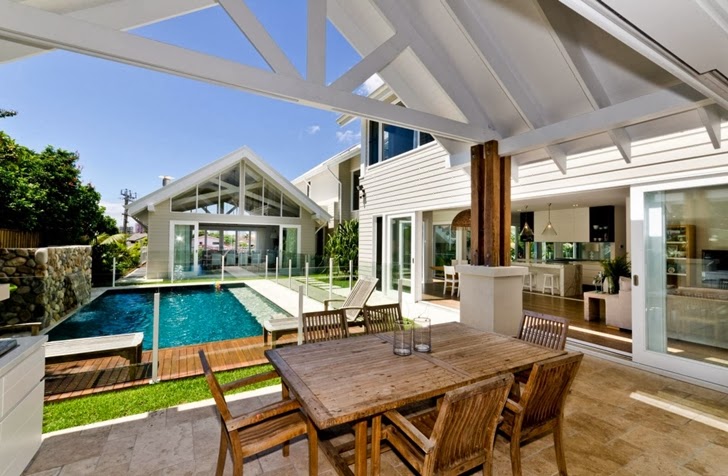 Wooden table in Beautiful seaside home by BGD Architects