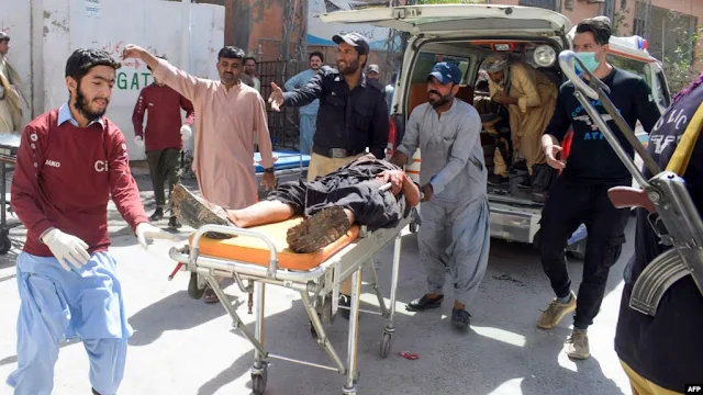 Cover Image Attribute: Volunteers carry a blast victim on a stretcher at a hospital in Quetta on September 29. / Source: AFP/RFE/RL