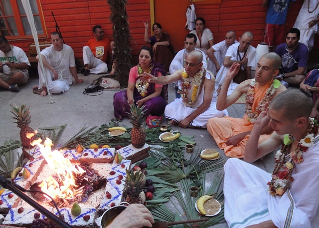 (Sankarshan Das) New Initiates Throw Grains in Sacrificial Fire