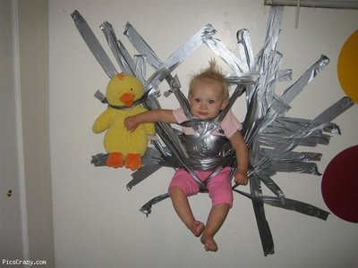 Baby duct taped to a wall