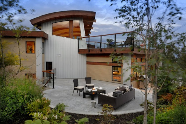 Photo of circular terrace with furniture in the backyard of armada house