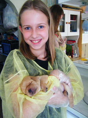 Katharine's all smiles as she holds one of the babies!