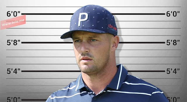 Bryson DeChambeau posing in front of a height chart background