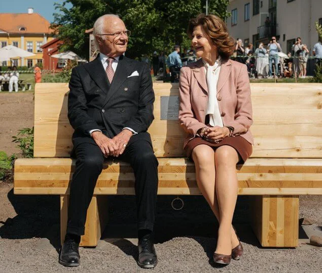 The King and Queen visited the House of Emigrants in Vaxjo. Queen Silvia wore a pink blazer and black skirt