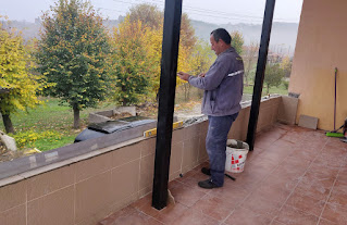 Bekir tiling the top of the wall again