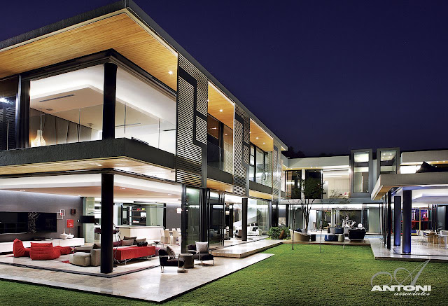 Picture of incredible dream home in South Africa at night as seen from the lawn in the backyard