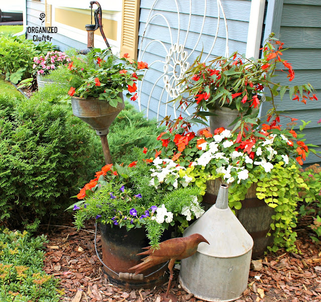 Photo of shade plants and garden junk on the front corner of the house.