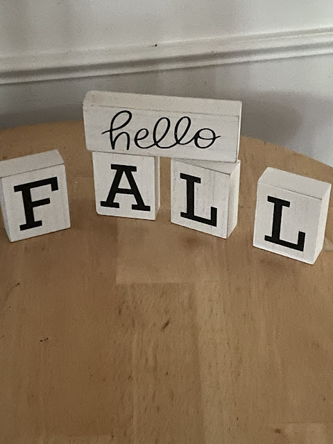 My 'hello fall' wooden fall decoration blocks on the circle table in the family room.
