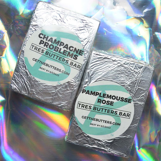 soap bars wrapped in foil against holographic background