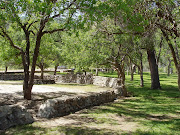 The part of the park we always stop at is a traditional county park with . (stone walls in park)