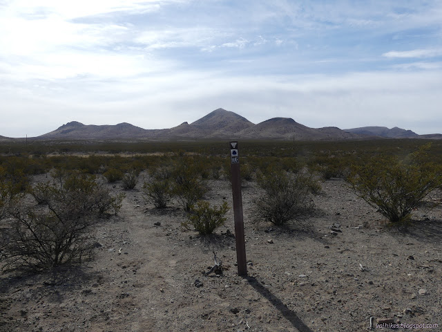 00: trailhead and a small range of mountains in the distance