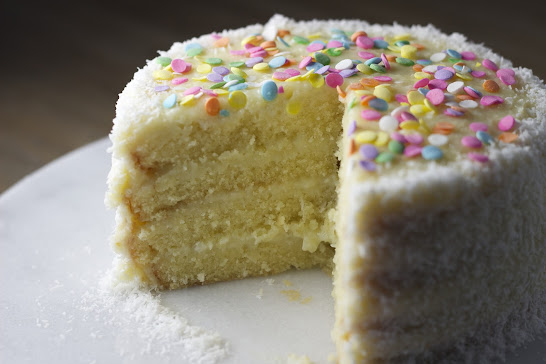 White vanilla birthday cake with candy confetti