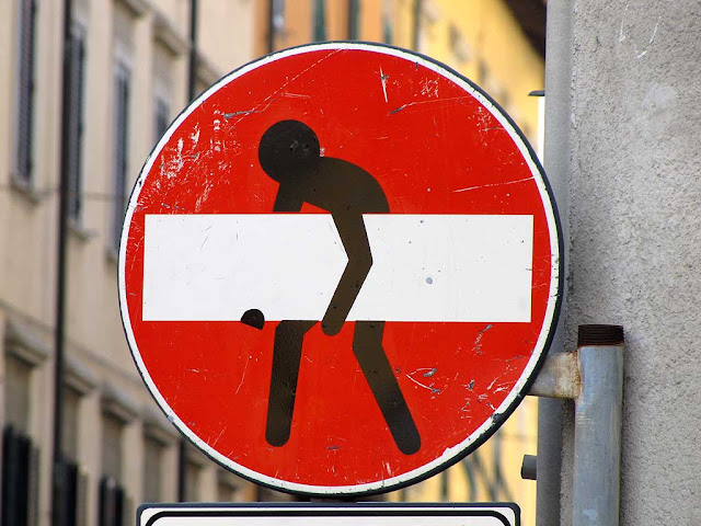 No entry sign with a guy carrying a huge beam, Clet Abraham, Livorno