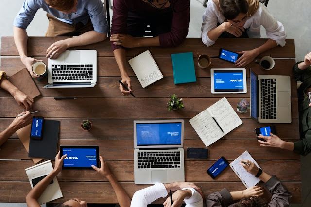 People using different computers to view important business information showing one way to improve internal communication at your business