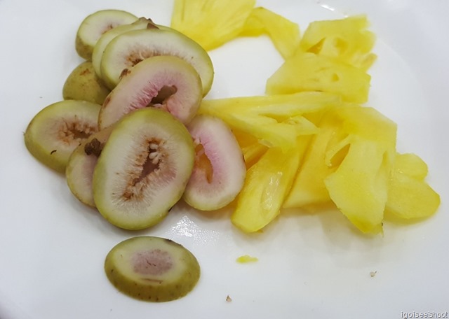 Figs and pineapple slices to be added to the goat meat and placed on rice paper. This is then hand rolled and dipped into a peanut sauce before eating.