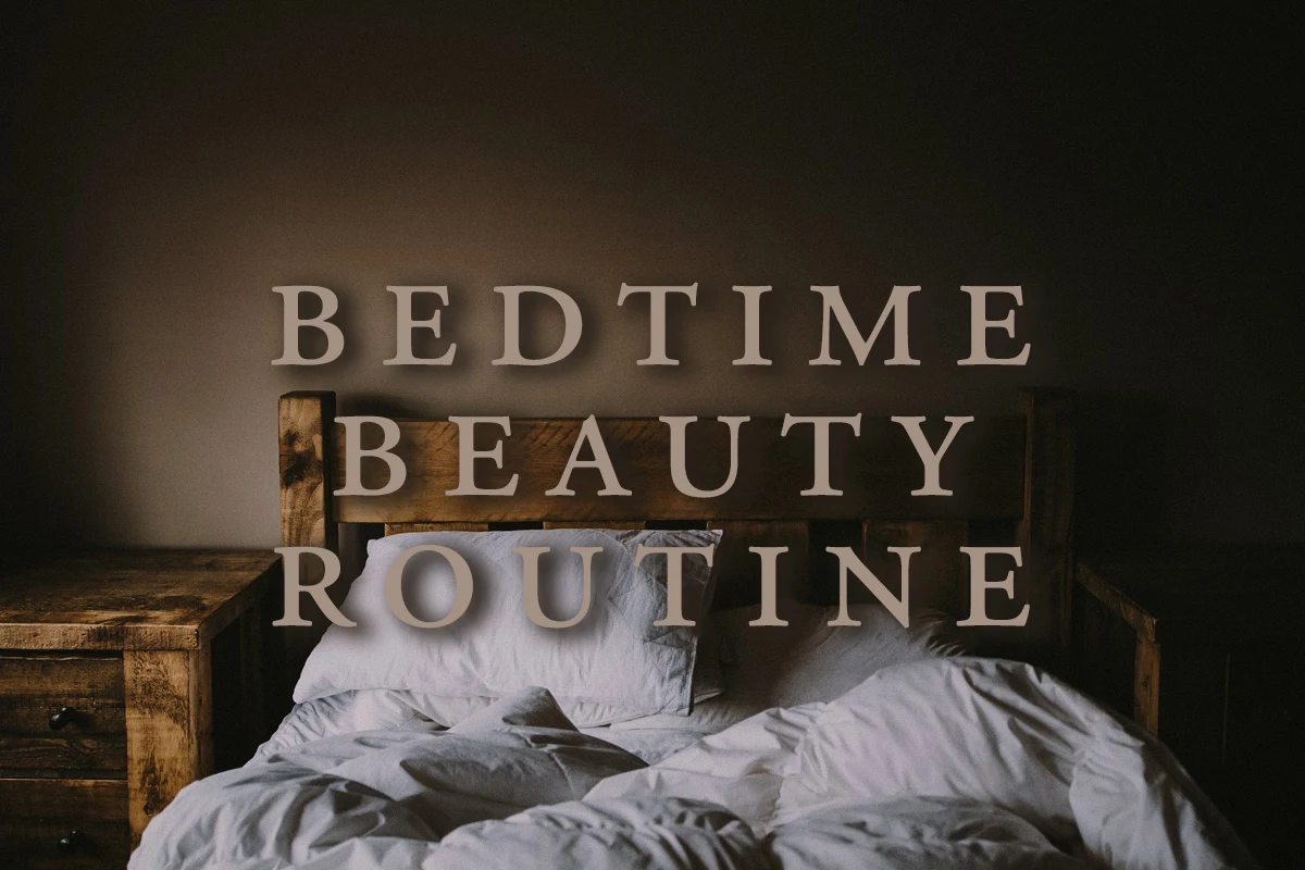 unmade bed with white bedding and a writting on a picture - bedtime beauty routine