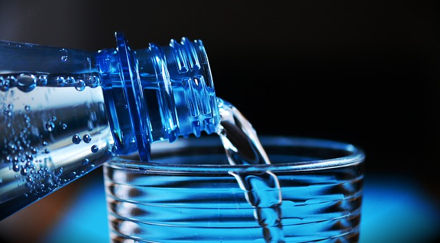 Pouring Bottled Water into a Glass