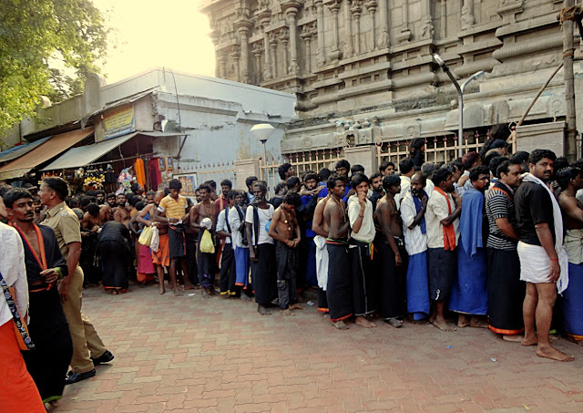 ayyappa devotees in a line outside temple